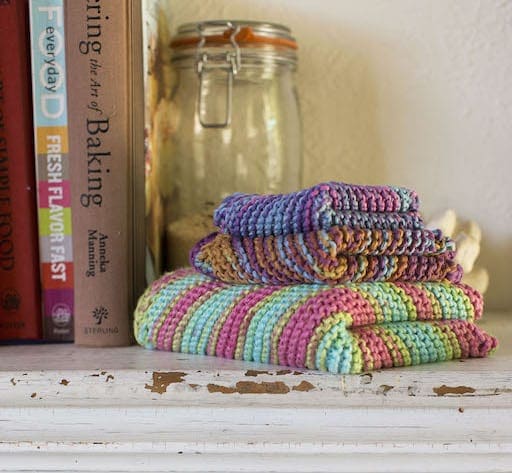 Two dishcloths and a rectangular hand towel folded